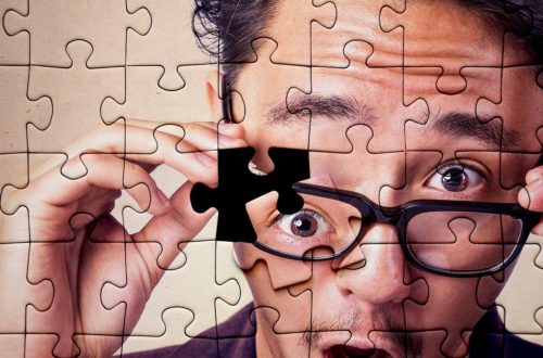 An eye is the last piece of a puzzle showing a surprised man wearing glasses.